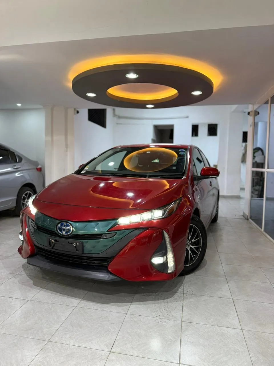 Toyota Prius PHV (Plug-In Hybrid) 2018 in Kenya Red Color 140k Mileage Alloy Rims Fog Lights Xenon Lights Electric And Petrol Hybrid