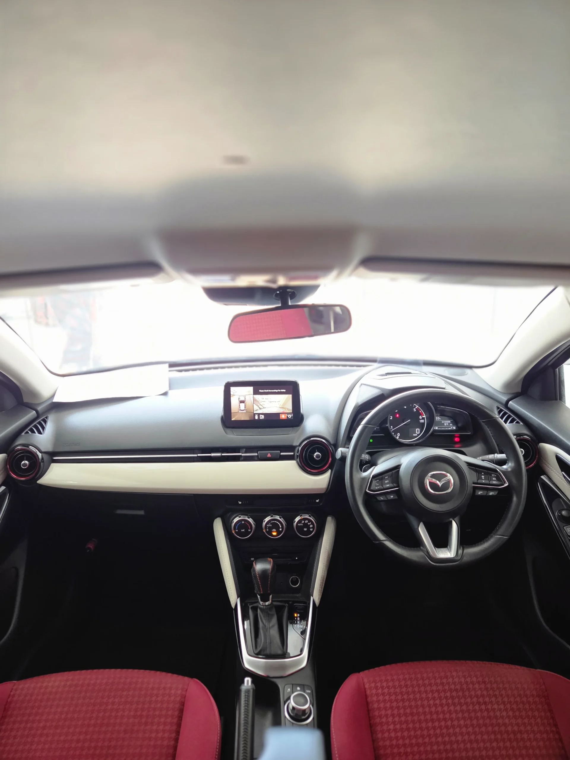 Stunning Noble Crimson interior of the 2018 Mazda Demio showing white leather trims and exclusive red seats.