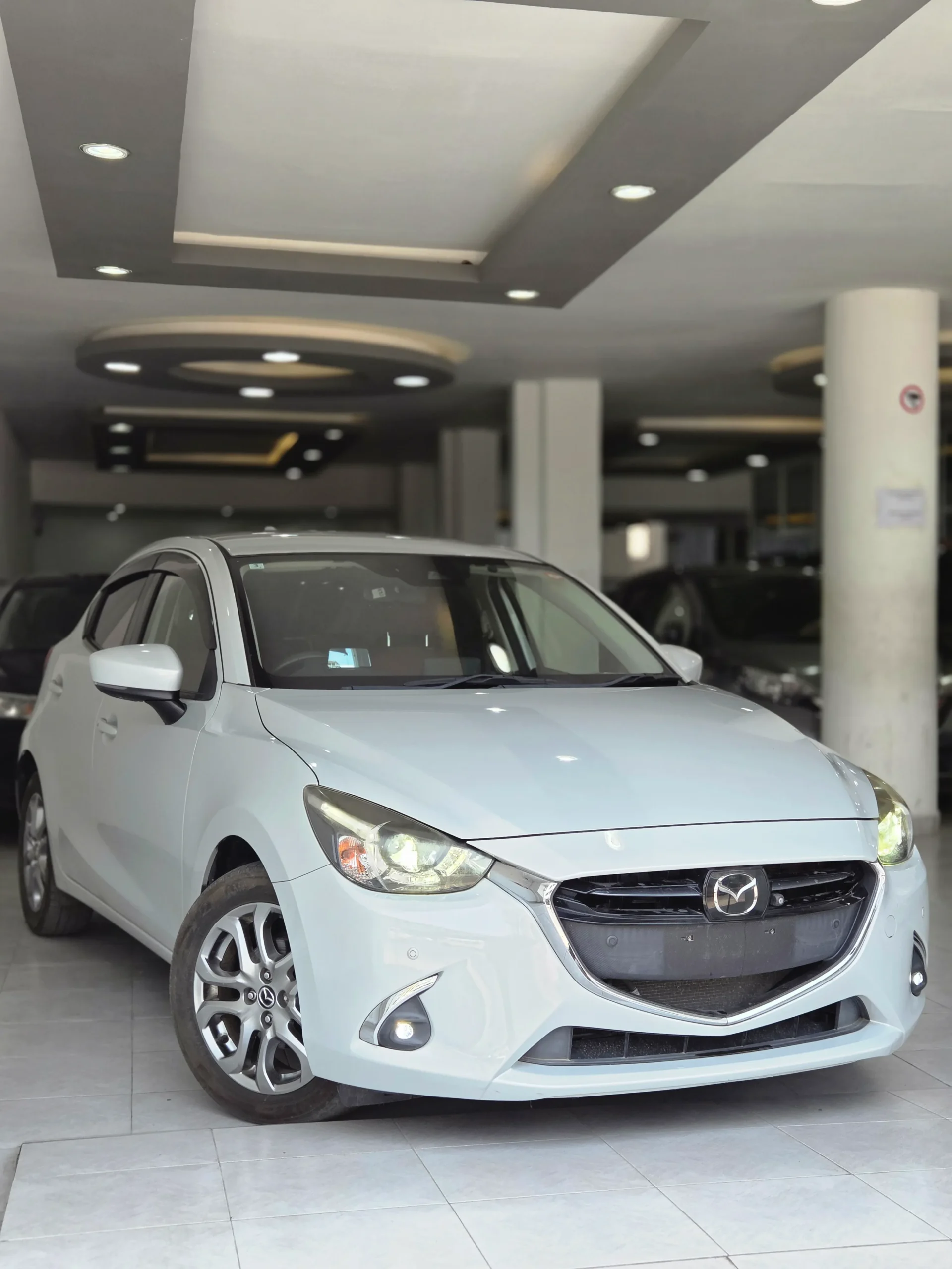 Ash grey Mazda Demio 2018 XD Touring Noble Crimson limited edition with LED headlights and alloy rims at Mundiya International Kenya.