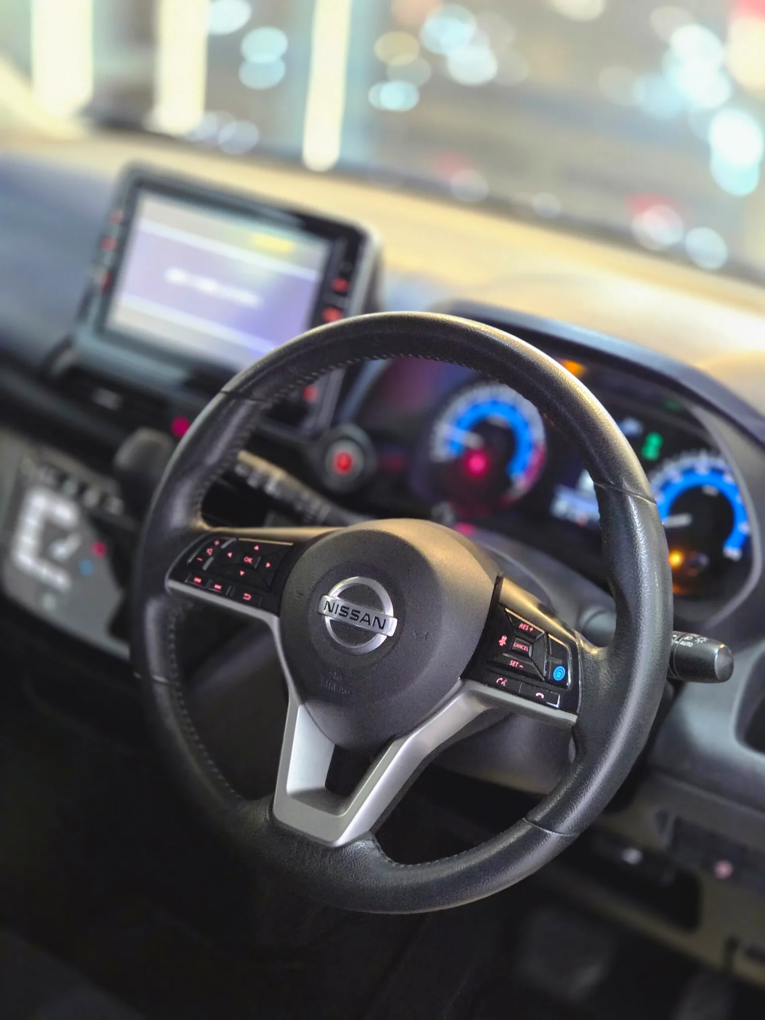 High-tech cabin of the Nissan Dayz Highway Star 2019 S-Hybrid ProPilot showing double-sided steering controls, touch-screen climate control, and ProPilot safety assist dashboard buttons.