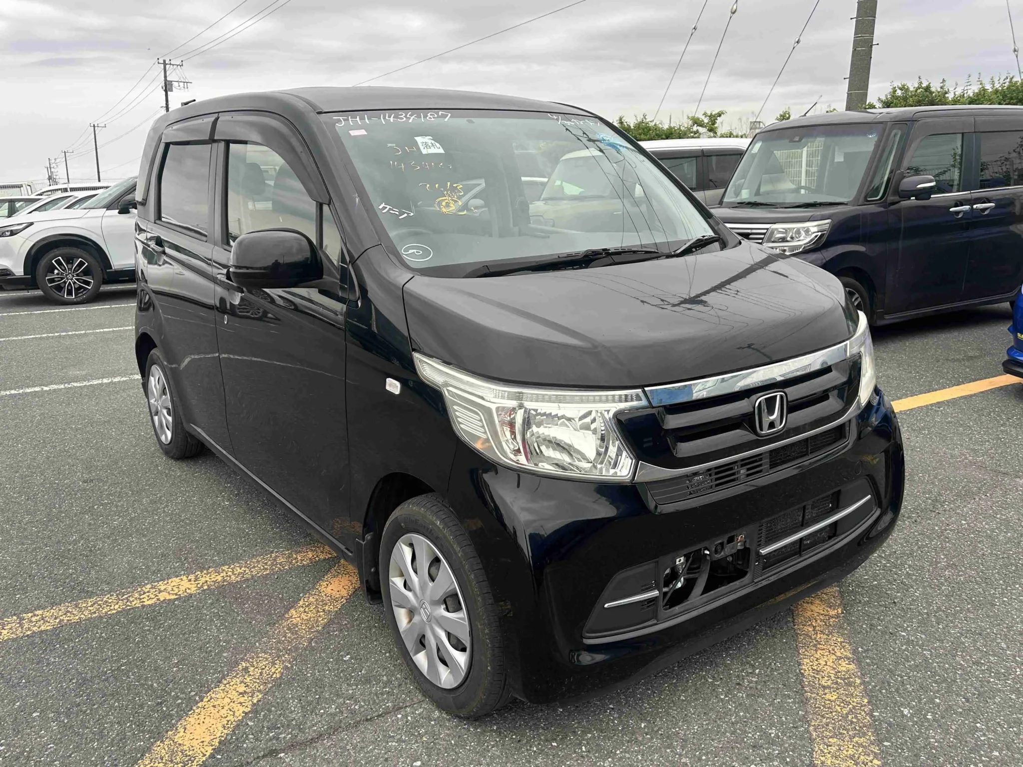 Sleek black Honda N-WGN 2019 G grade hatchback showing its modern boxy profile, distinctive chrome-trimmed grille, and large headlights at Mundiya International Kenya.