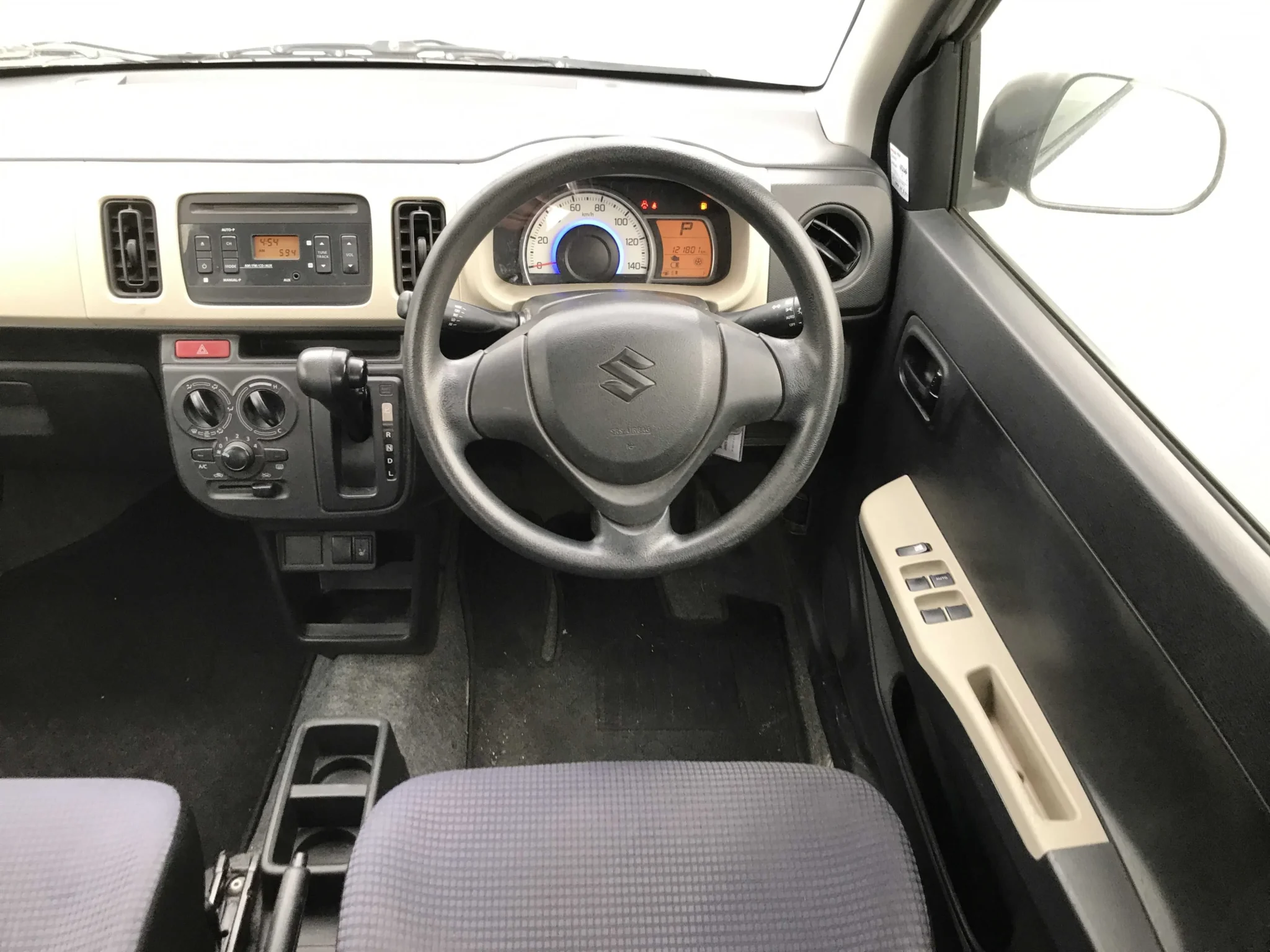 Functional driver cabin layout of the 2019 Suzuki Alto highlighting the dashboard instrument cluster, integrated gear selector, and the premium master switches controlling all 4 power windows.